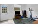 Living area featuring neutral tile floors, a television, exercise equipment, and natural light from a window at 9402 71St E Ave, Palmetto, FL 34221