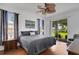 Comfortable bedroom featuring a king-size bed, a ceiling fan, wood floors, and a sliding door to the lanai at 9402 71St E Ave, Palmetto, FL 34221