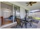 Covered patio with a ceiling fan, table, chairs and access to the house through sliding glass doors at 9402 71St E Ave, Palmetto, FL 34221