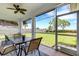 Screened-in patio with a view of the backyard, with a table and chairs for outdoor dining at 9402 71St E Ave, Palmetto, FL 34221