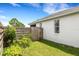 Side yard with a lush garden area and a well-maintained wooden fence for privacy at 9402 71St E Ave, Palmetto, FL 34221