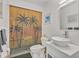 Bathroom features a vessel sink, palm tree shower curtain and decorative wall art at 107 Van Dyck Dr, Nokomis, FL 34275
