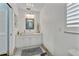 Well-lit bathroom features a modern vanity, ample storage, and a clean design, creating a refreshing and functional space at 107 Van Dyck Dr, Nokomis, FL 34275
