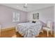 Bedroom features a queen bed with patterned bedding, white ceiling fan and neutral walls at 107 Van Dyck Dr, Nokomis, FL 34275