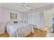 Bedroom features a queen bed with patterned bedding, white ceiling fan and neutral walls at 107 Van Dyck Dr, Nokomis, FL 34275