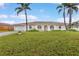 Charming single-story home features a well-manicured lawn, arched entry, and attached garage at 107 Van Dyck Dr, Nokomis, FL 34275