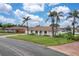Charming single-story home boasting a beige tile roof, well-kept lawn, and mature palm trees at 107 Van Dyck Dr, Nokomis, FL 34275