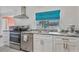 Well-lit kitchen with stainless steel appliances, ample counter space, and bright white cabinetry, creating a modern, clean aesthetic at 107 Van Dyck Dr, Nokomis, FL 34275