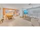 Open-concept living and dining area with tile flooring and a coastal color palette at 107 Van Dyck Dr, Nokomis, FL 34275