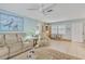 Bright living room with tile floors, cozy furniture, and decorative accents at 107 Van Dyck Dr, Nokomis, FL 34275