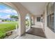 A charming covered porch with tiled flooring and decorative columns at 107 Van Dyck Dr, Nokomis, FL 34275