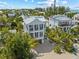 Expansive aerial view of this luxury home, beautifully landscaped with tropical palms and manicured lawn at 109 Palmetto Ave, Anna Maria, FL 34216