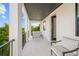 Relaxing balcony with seating area overlooking a lush tropical landscape at 109 Palmetto Ave, Anna Maria, FL 34216
