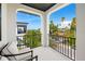 Spacious balcony with seating area and stunning view of the ocean and palm trees at 109 Palmetto Ave, Anna Maria, FL 34216