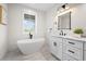 Bright bathroom featuring soaking tub, single vanity, and black hardware at 109 Palmetto Ave, Anna Maria, FL 34216