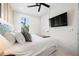 Serene bedroom with mounted TV, ceiling fan, bright window, and relaxing atmosphere at 109 Palmetto Ave, Anna Maria, FL 34216