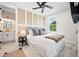 Bedroom boasts a textured accent wall, ceiling fan, ensuite access, and natural light at 109 Palmetto Ave, Anna Maria, FL 34216