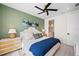 Charming bedroom with green accent wall, stylish decor, and ensuite bathroom access at 109 Palmetto Ave, Anna Maria, FL 34216