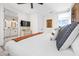 Comfortable bedroom with accent wall, a TV, a dresser, and an ensuite bathroom at 109 Palmetto Ave, Anna Maria, FL 34216