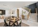 Inviting dining area with a round table, set for a meal, next to the stairway at 109 Palmetto Ave, Anna Maria, FL 34216