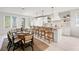 Stunning kitchen with a breakfast bar, dining table, and black and white backsplash at 109 Palmetto Ave, Anna Maria, FL 34216