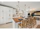 Spacious kitchen featuring a large island, custom cabinetry, and modern lighting at 109 Palmetto Ave, Anna Maria, FL 34216