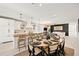 Open-concept kitchen and dining area featuring a large island and dining table at 109 Palmetto Ave, Anna Maria, FL 34216