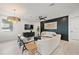Cozy living room featuring a dark accent wall, modern furniture and decor at 109 Palmetto Ave, Anna Maria, FL 34216