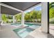 Luxury pool and spa area with tropical landscaping and covered patio with bright open concept design at 109 Palmetto Ave, Anna Maria, FL 34216