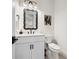 Chic powder room featuring elegant mirror, stylish vanity, and modern fixtures at 109 Palmetto Ave, Anna Maria, FL 34216
