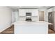 Elegant kitchen showcasing white cabinets, stainless steel appliances, and a marble island at 12064 Lansing Gln, Parrish, FL 34219