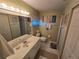 Bathroom with a single sink vanity, framed mirror, tile flooring, and a walk in shower at 1211 Capri Isles Blvd # 116, Venice, FL 34292