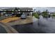 Assigned carport parking for residents with landscaped common areas surrounding the property at 1211 Capri Isles Blvd # 116, Venice, FL 34292