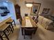 Dining room featuring a table with seating for six open to the kitchen and living room at 1211 Capri Isles Blvd # 116, Venice, FL 34292