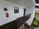 Exterior of condo featuring unit number, stairway, and nearby landscaping at 1211 Capri Isles Blvd # 116, Venice, FL 34292
