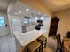 Bright kitchen featuring white cabinets, updated appliances, and a breakfast bar at 1211 Capri Isles Blvd # 116, Venice, FL 34292