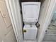 Efficient laundry closet with stacked washer and dryer for convenient in-home laundry at 1211 Capri Isles Blvd # 116, Venice, FL 34292