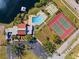 Aerial shot showcasing a pool, tennis courts, and lake access with a gazebo at 1227 56Th St W # 1227, Bradenton, FL 34209