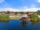 Scenic aerial shot of a lakefront gazebo, community pool, and tennis courts at 1227 56Th St W # 1227, Bradenton, FL 34209