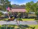 Exterior of a well-maintained clubhouse with holiday decorations and lush greenery at 1227 56Th St W # 1227, Bradenton, FL 34209