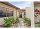 Inviting front entrance with tiled walkway and lush landscaping leading to the front door at 1227 56Th St W # 1227, Bradenton, FL 34209