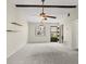 Bright living room with carpet, decorative wood beams, and ample natural light at 1227 56Th St W # 1227, Bradenton, FL 34209