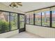 Enclosed sunroom featuring tile floor and multiple windows providing views of the backyard at 1227 56Th St W # 1227, Bradenton, FL 34209