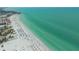 Stunning aerial view of the beach, white sand and blue waters, showcasing a vibrant coastal community at 1250 N Portofino Dr # 208, Sarasota, FL 34242