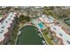 Aerial view of waterfront condos, pool, canal, and boat docks, showcasing community amenities at 1250 N Portofino Dr # 208, Sarasota, FL 34242