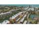 Aerial view of condo complex with waterfront access, boat docks, parking, and stunning coastal community at 1250 N Portofino Dr # 208, Sarasota, FL 34242