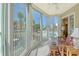Sunny enclosed lanai with seating, ceiling fan, and expansive views of the pool and surrounding community at 1250 N Portofino Dr # 208, Sarasota, FL 34242