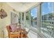 Enclosed lanai featuring comfortable seating, a ceiling fan, and a stunning waterfront view of the canal at 1250 N Portofino Dr # 208, Sarasota, FL 34242