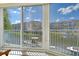 Enclosed lanai boasting stunning views of the canal, clear blue skies, and boats docked along the waterfront at 1250 N Portofino Dr # 208, Sarasota, FL 34242