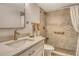 Bathroom featuring bright natural light and a tan tile standing shower with safety bars at 1250 N Portofino Dr # 208, Sarasota, FL 34242
